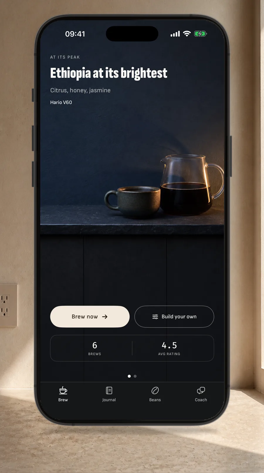 A straight iPhone on a sunlit kitchen counter showing Brew Today recommending an Ethiopia Hario V60 at peak freshness.