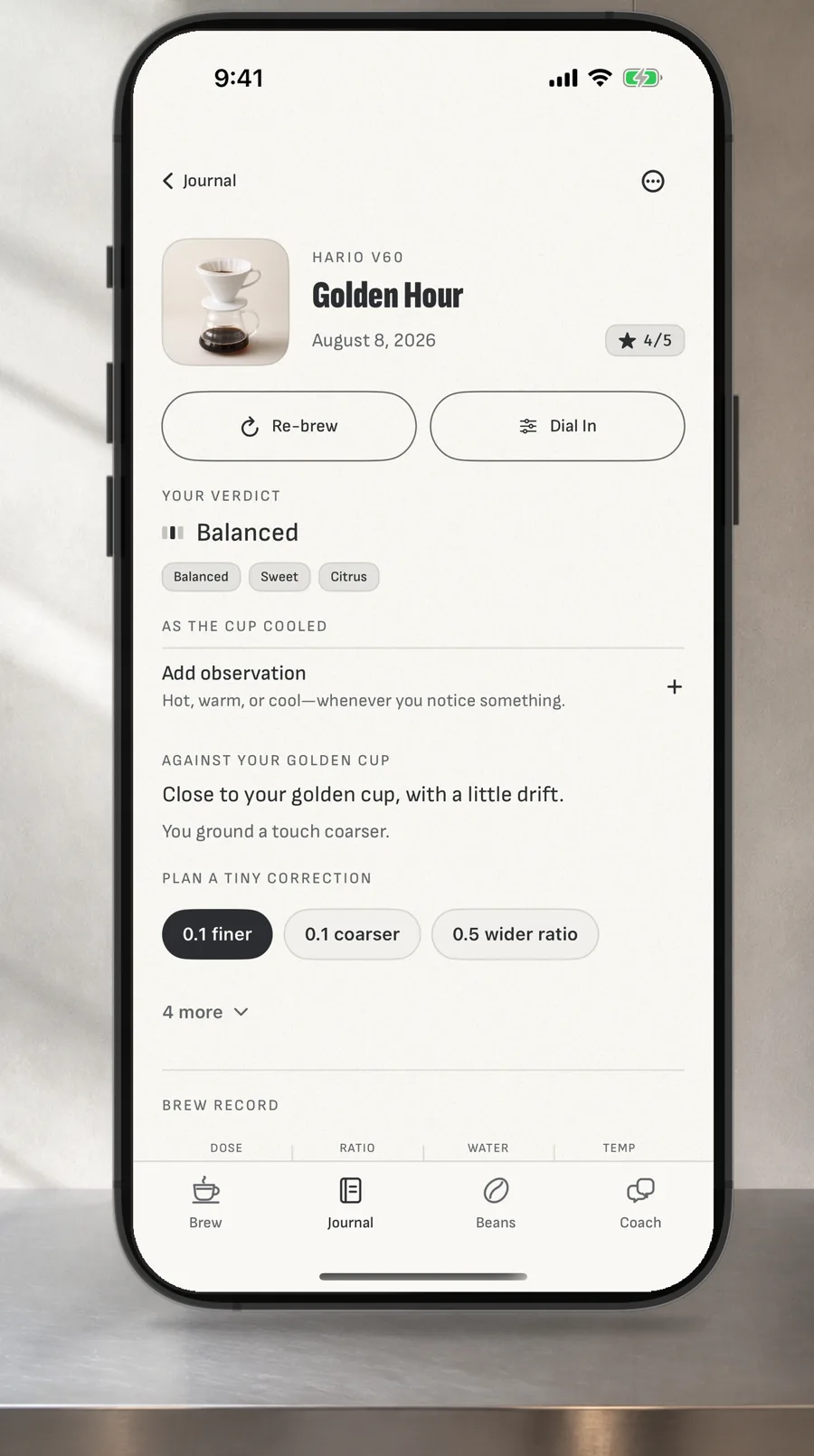 A straight iPhone on a kitchen worktop showing Logica Coffee's brew journal.