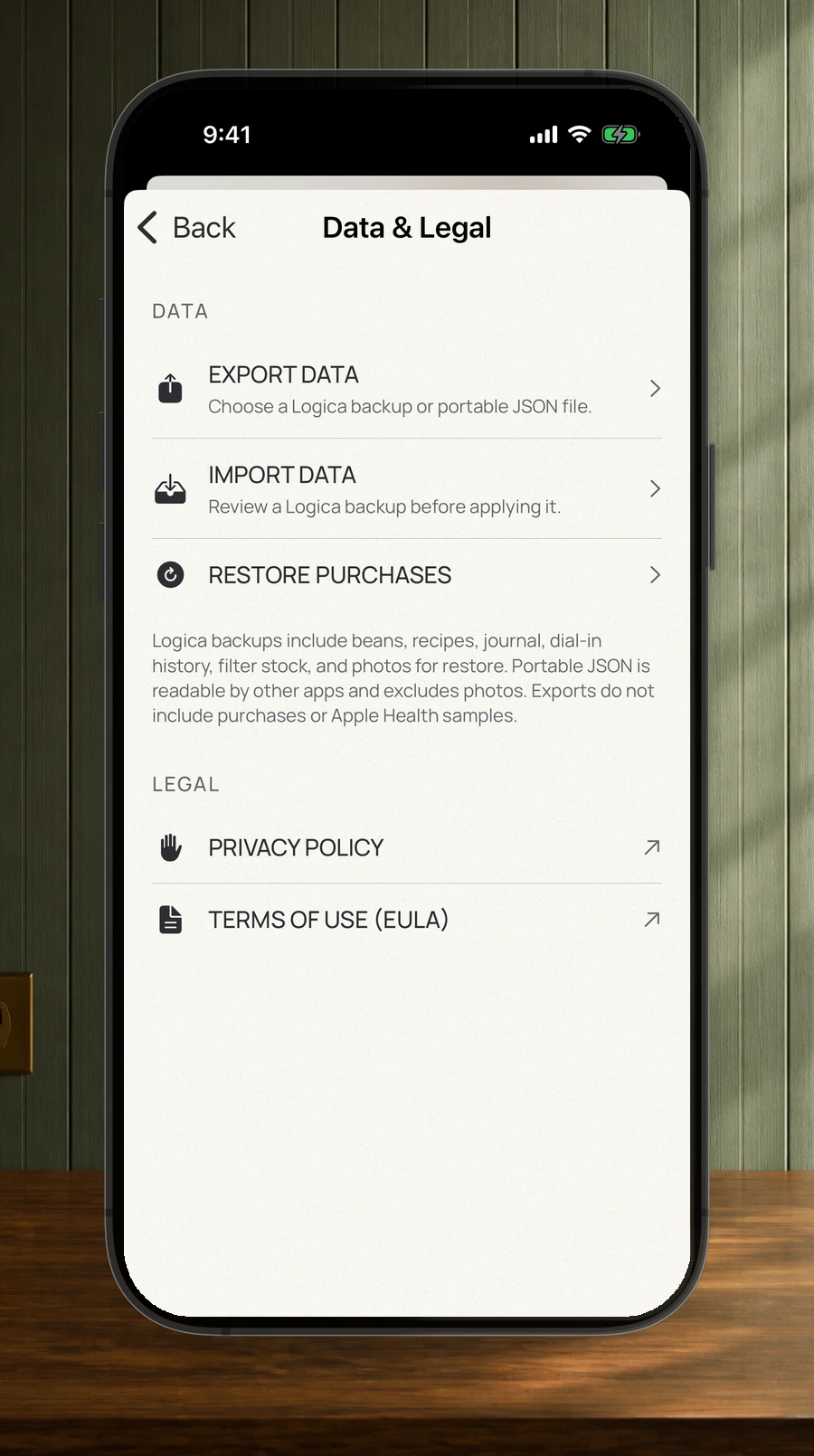 A straight iPhone showing Data & Legal controls for export, import, restore purchases, privacy policy, and terms of use.